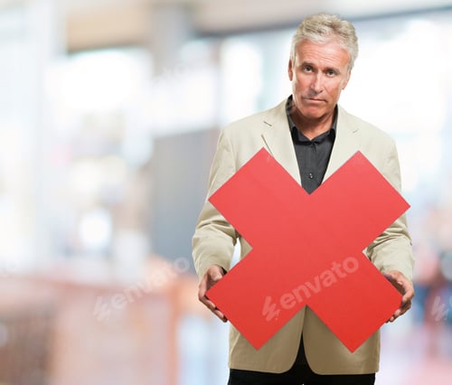 Preview: Serious Man Holding Red Cross Sign, Indoor