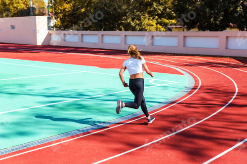 Preview: Portrait Of A Woman Running At Stadium