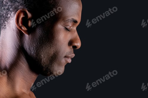 Preview: Calm And Confident. Side View Of Young African Man Keeping Eyes Closed While Standing Against Grey