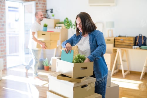 Preview: Young Couple Moving To New Apartment, Beautiful Woman Moving Cardboard Boxes And Smiling Happy