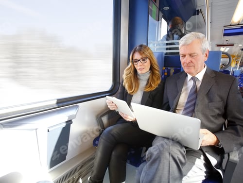 Preview: Portrait Of Middle Age Businesswoman Holding In Her Hand A Digital Tablet While Senior Businessman