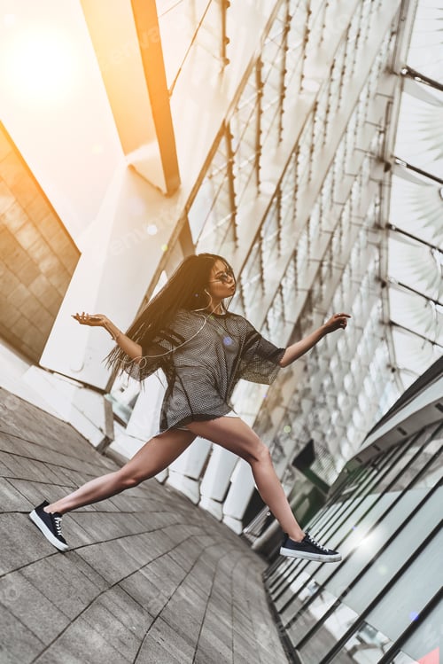 Preview: Enjoying Carefree Time. Attractive Young Woman In Casual Wear Holding A Smart Phone While Moving
