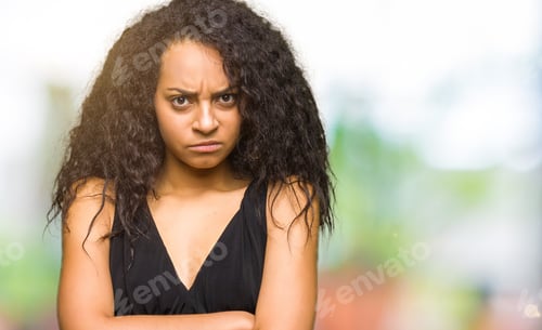 Preview: Young Beautiful Girl With Curly Hair Wearing Fashion Skirt Skeptic And Nervous, Disapproving