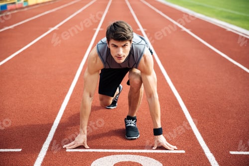 Preview: Portrait Of The Young Muscular Concentrated Athlete At The Start Of The Treadmill At The Stadium