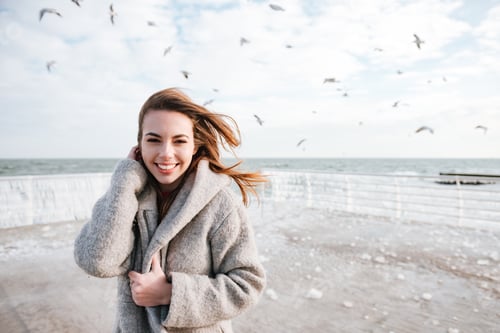 Preview: Happy Lovely Young Woman Smiling And Walking On Pier In Winter
