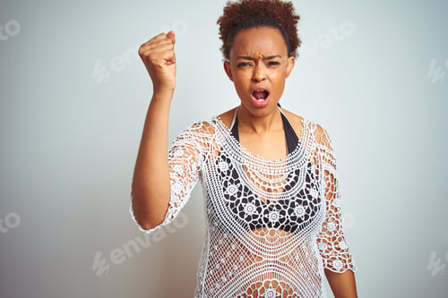 Preview: Young African American Woman With Afro Hair Wearing A Bikini Over White Isolated Background Angry