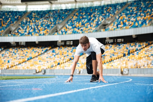 Preview: Young Male Sprinter About To Start A Race At The Stadium