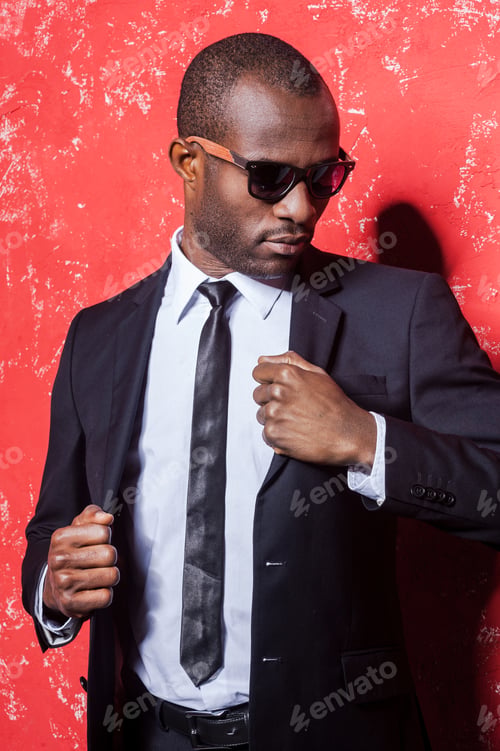Preview: Looking Just Perfect. Handsome Young African Man In Formalwear And Sunglasses Adjusting His Jacket