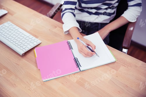 Preview: Closeup Portrait Of A Casual Woman Writing Notes In Office