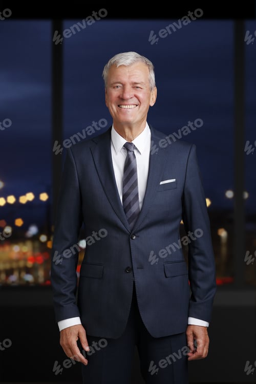 Preview: Portrait Of Successful Senior Businessman Standing At Office After Late Night Working.