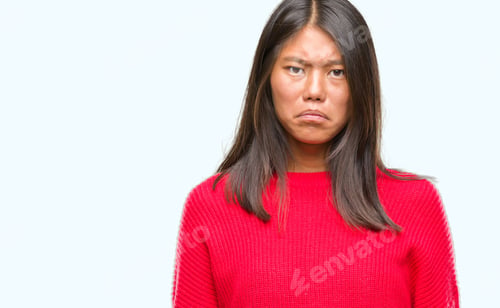 Preview: Young Asian Woman Wearing Winter Sweater Over Isolated Background Depressed And Worry For Distress