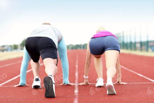 Preview: Man And Woman Racing On Outdoor Track
