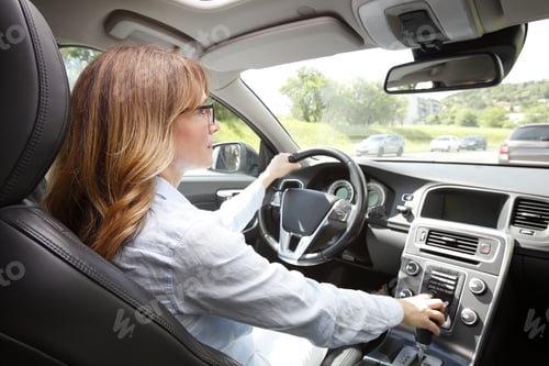 Preview: Portrait Of Middle Aged Woman Driving A Car.