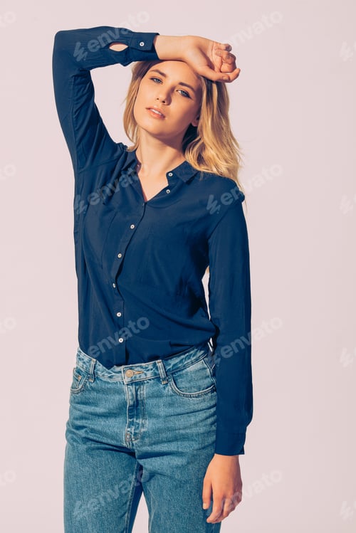 Preview: Fashionable Beauty. Studio Shot Of Beautiful Young Woman Wearing Black Shirt Holding Hand Over Head