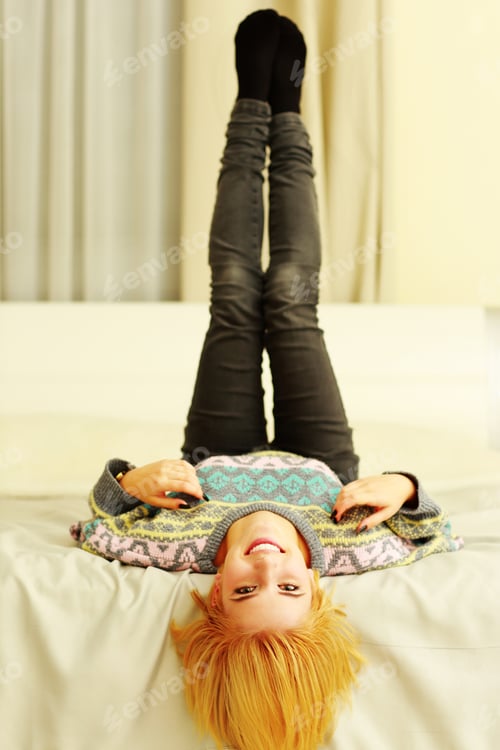 Preview: Young Cheerful Woman Lying On The Bed At Home