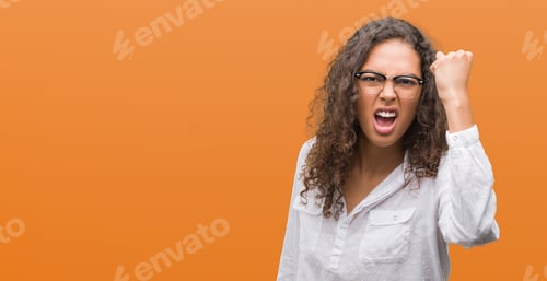 Preview: Beautiful Young Hispanic Woman Angry And Mad Raising Fist Frustrated And Furious While Shouting