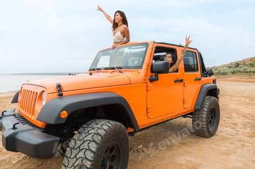 Preview: Two Beautiful Young Women Having Fun While Driving A Car At The Beach