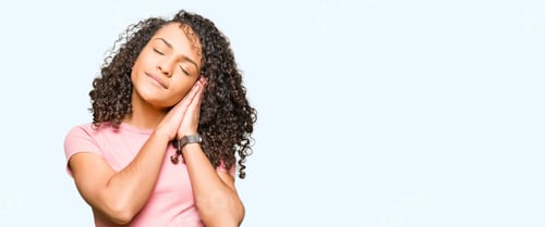 Preview: Young Beautiful Woman With Curly Hair Wearing Pink T-Shirt Sleeping Tired Dreaming And Posing With