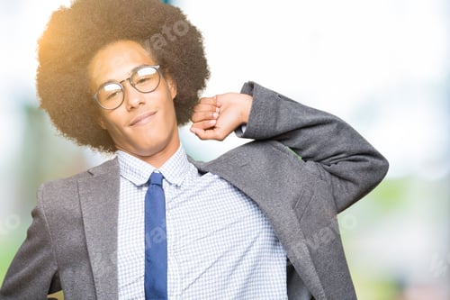 Preview: Young African American Business Man With Afro Hair Wearing Glasses Stretching Back, Tired And