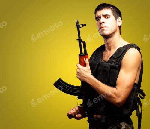 Preview: Portrait Of Soldier Holding Gun Against A Yellow Background