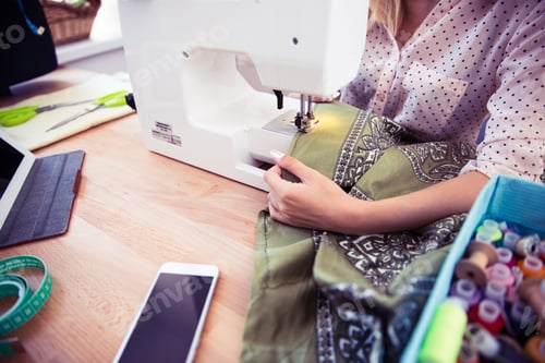 Preview: Closeup Portrait Of A Woman Using A Sewing Machine