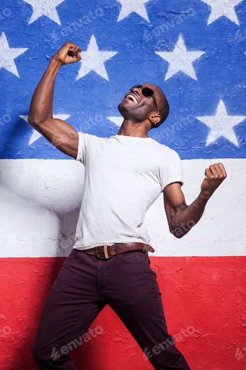 Preview: The Happiest In The World! Happy Young African Man In Sunglasses Raising His Arms Up And Smiling