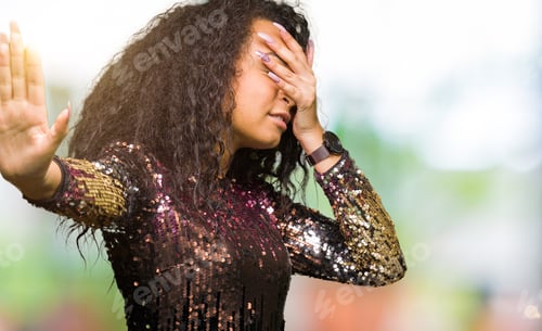 Preview: Young Beautiful Girl With Curly Hair Wearing Night Party Dress Covering Eyes With Hands And Doing