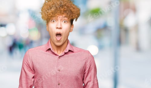 Preview: Young Handsome Business Man With Afro Hair Afraid And Shocked With Surprise Expression, Fear And