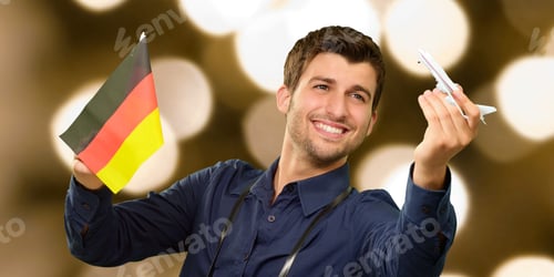 Preview: Photographer Holding German Flag And Miniature Airplane, Indoor