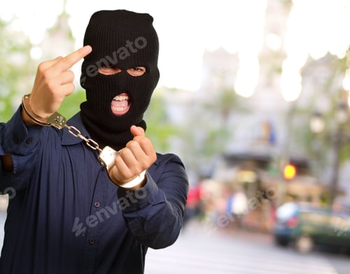 Preview: Angry Criminal Man Locked In Handcuffs, Outdoor