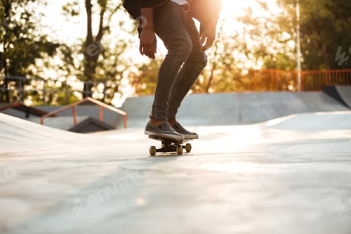 Preview: Afro American Man Performing A Trick On A Skateboard Outdoors