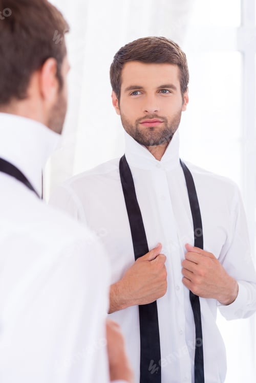 Preview: Preparing To A Special Day. Handsome Young Man In White Shirt And Untied Necktie Standing Against