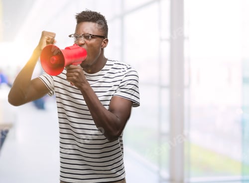 Preview: Young African American Man Holding Megaphone Annoyed And Frustrated Shouting With Anger, Crazy And