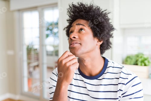 Preview: African American Man Wearing Stripes T-Shirt With Hand On Chin Thinking About Question, Pensive