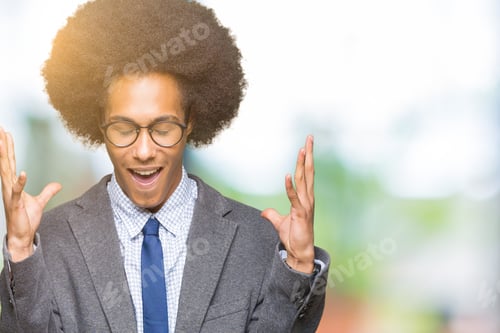 Preview: Young African American Business Man With Afro Hair Wearing Glasses Celebrating Mad And Crazy For