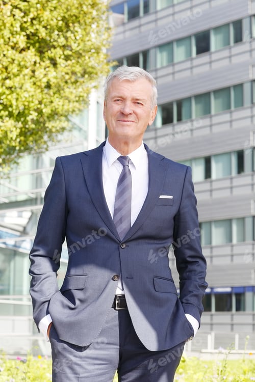 Preview: Portrait Of Senior Businessman Standing At Office Building After Business Meeting.