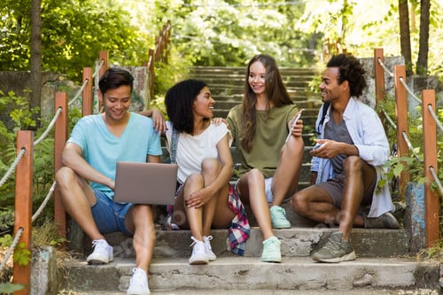 Preview: Picture Of Young Multiethnic Friends Students Outdoors Using Mobile Phone And Laptop Computer And