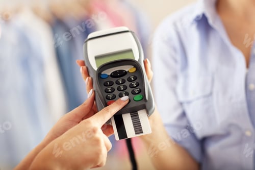 Preview: Closeup Mid Section Of Female Customer Paying In Shop With Credit Card