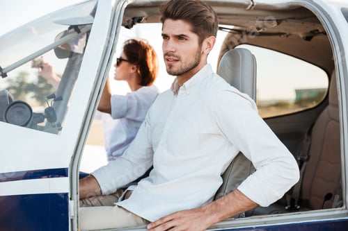 Preview: Young Pilot And Beautiful Stewardess Sitting Together Inside Airplane Cabin