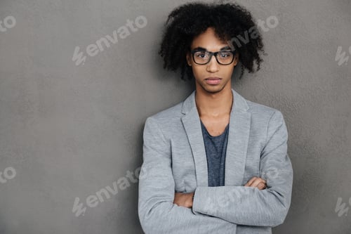 Preview: Young And Confident. Confident Young African Man Keeping Arms Crossed And Looking At Camera While