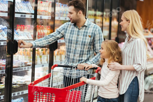 Preview: Happy Family With Child And Shopping Cart Buying Food At Grocery Store Or Supermark