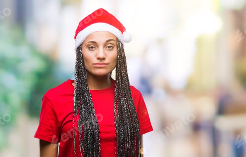 Preview: Young Braided Hair African American Girl Wearing Christmas Hat Over Isolated Background With