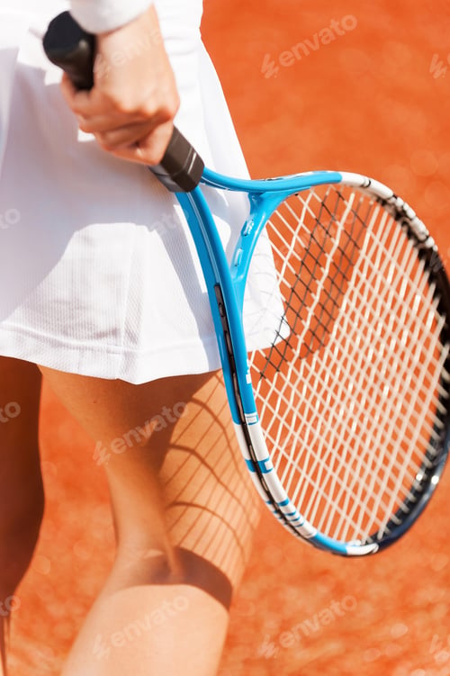 Preview: Elegance In Every Move. Close-Up Of Beautiful Woman In Sports Clothing Holding Tennis Racket