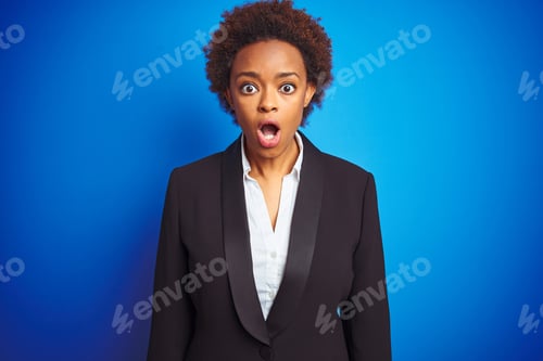 Preview: African American Business Executive Woman Over Isolated Blue Background Afraid And Shocked With