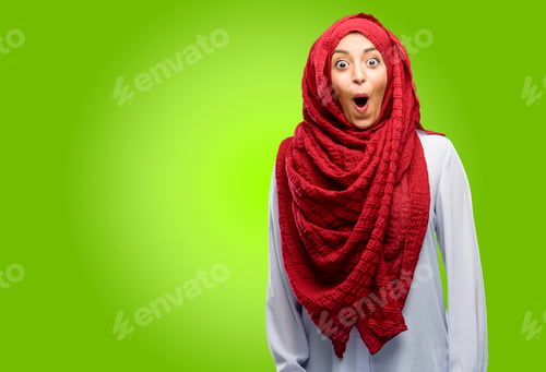 Preview: Young Arab Woman Wearing Hijab Happy And Surprised Cheering Expressing Wow Gesture