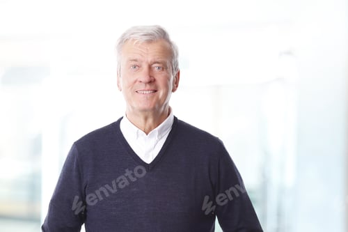 Preview: Portrait Of Retired Professional Man Standing At Office While Looking At Camera And Smiling.