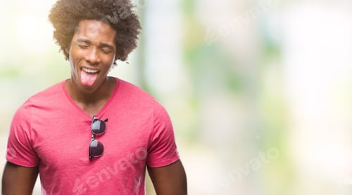 Preview: Afro American Man Over Isolated Background Sticking Tongue Out Happy With Funny Expression. Emotion