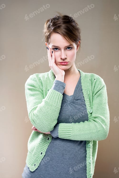 Preview: Portrait Of Beautiful Young Brunette Woman With Tired, Pondering Facial Expression.