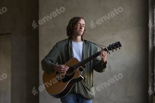 Preview: Shot Of A Young Musician Playing His Acoustic Guitar.