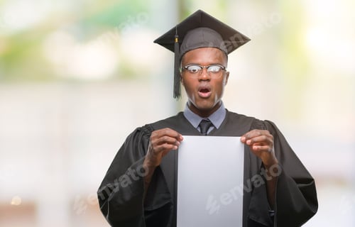 Preview: Young Graduated African American Man Holding Blank Paper Degree Over Isolated Background Scared In